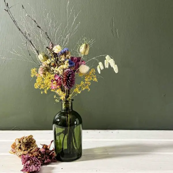 colourful dried flower posy in glass vase