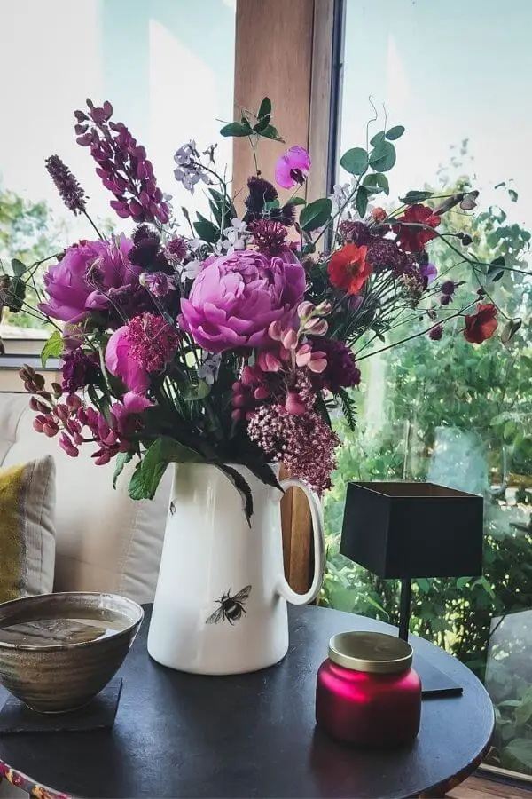 How to Grow Cut Flowers in Small Spaces (Even Without a Garden or Spare Time) 2 pink Peonies in a jug of garden flowers